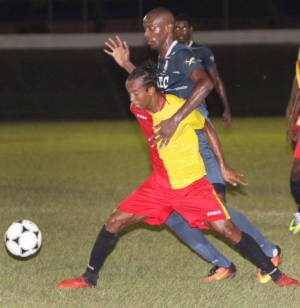 North East Stars’ Kyle Bartholomew, left, protects the ball from a Police defender during a Pro League match at the Arima Velodrome last season.