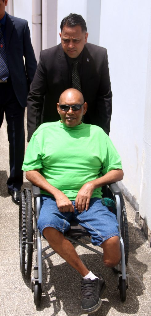 TESTIFIED: Amputee Arnold Lallbeharry, 53 is wheeled out of the San Fernando Magistrates Court yesterday. PHOTO BY ANSEL JEBODH