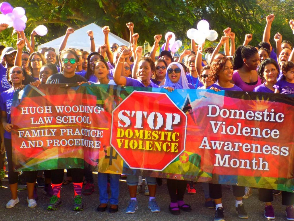 Staff and students of the Hugh Wooding Law School march against domestic violence at the campus grounds in St Augustine on March 2. Experts believe teaching boys and girls how to solve conflicts without violence is key to stopping the problem. FILE PHOTO