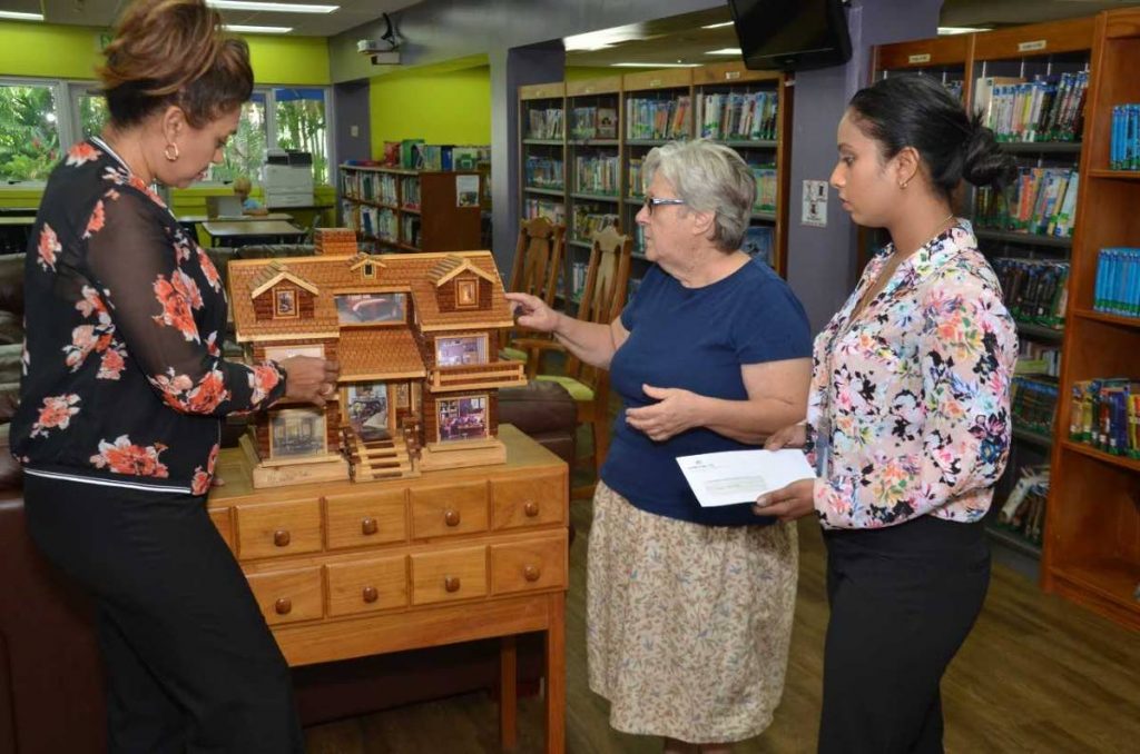 Debbie Jacob, librarian and teacher, centre, discuss her projects at the Port of Spain Prisons with Sharon Balroop, ANSA McAL group communications manager and Natasha Ramnath ANSA McAL group corporate communications officer.