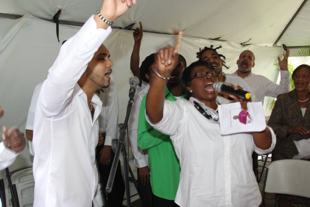 Prison ministry: Choir director Patricia Morris leads inmates in praise during their performance at a service held at the Port of Spain prison on March 28. 
