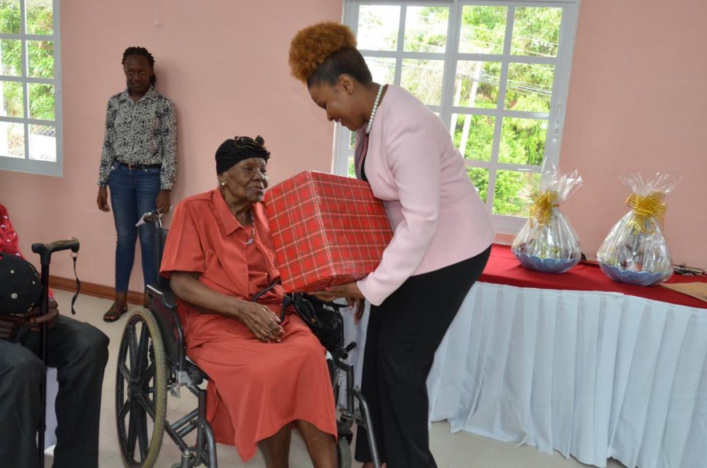Patricia Reneaud who turns 102 today receives her token from Dr  Nyan Gadsby-Dolly.
