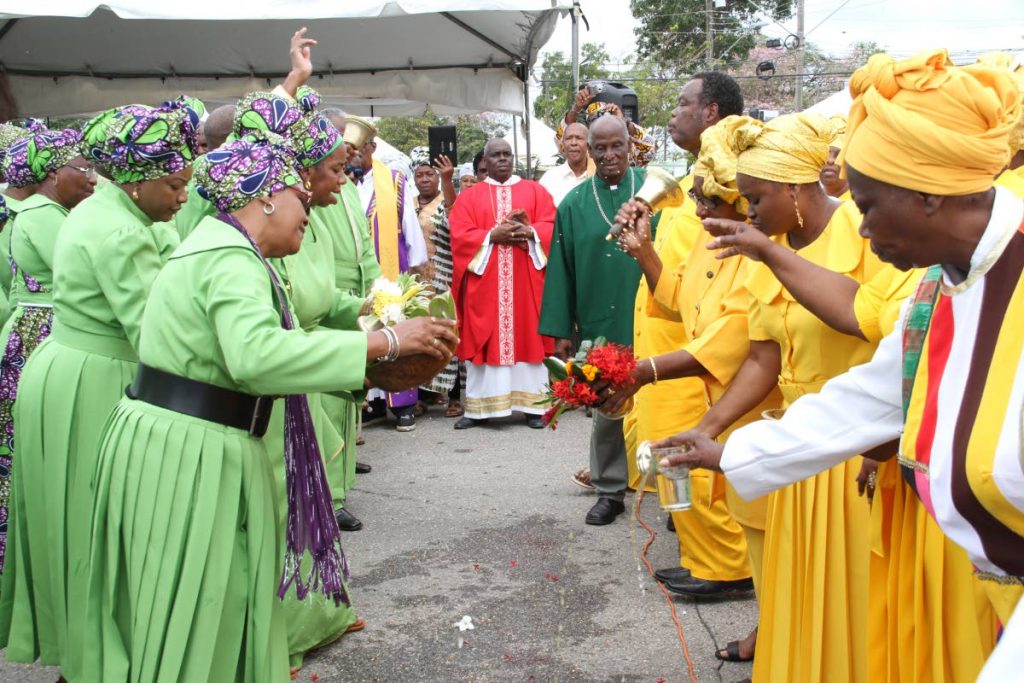 April 1, 2018. Members of Spiritual Baptist churches greet each other with offerings of water and flowers at the the National Congress of Incorporated Bapatist Organisations of TT's Liberation Day celebrations at Eddie Hart Grounds, Tacarigua. PHOTOS BY SUREASH CHOLAI