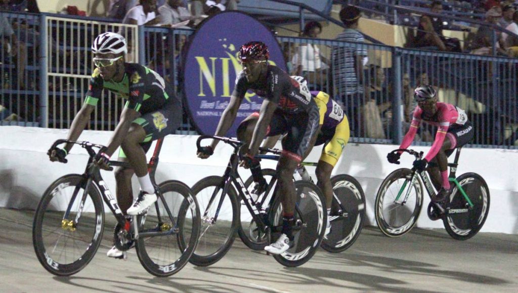 In the Men’s Elite 1 race, Jamol Eastmond, right, placed first in the event at Easter Cycling Classic, on Friday night, at the Arima Velodrome.
