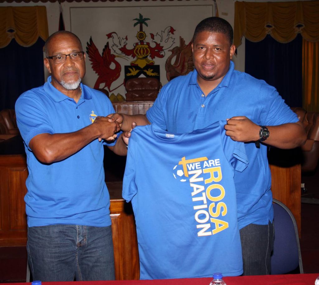 FC Santa Rosa president/owner/CEO Keith Look Loy (left) congraulates newly-appointed team coach Derek King during a media conference at the Arima Town Hall yesterday.