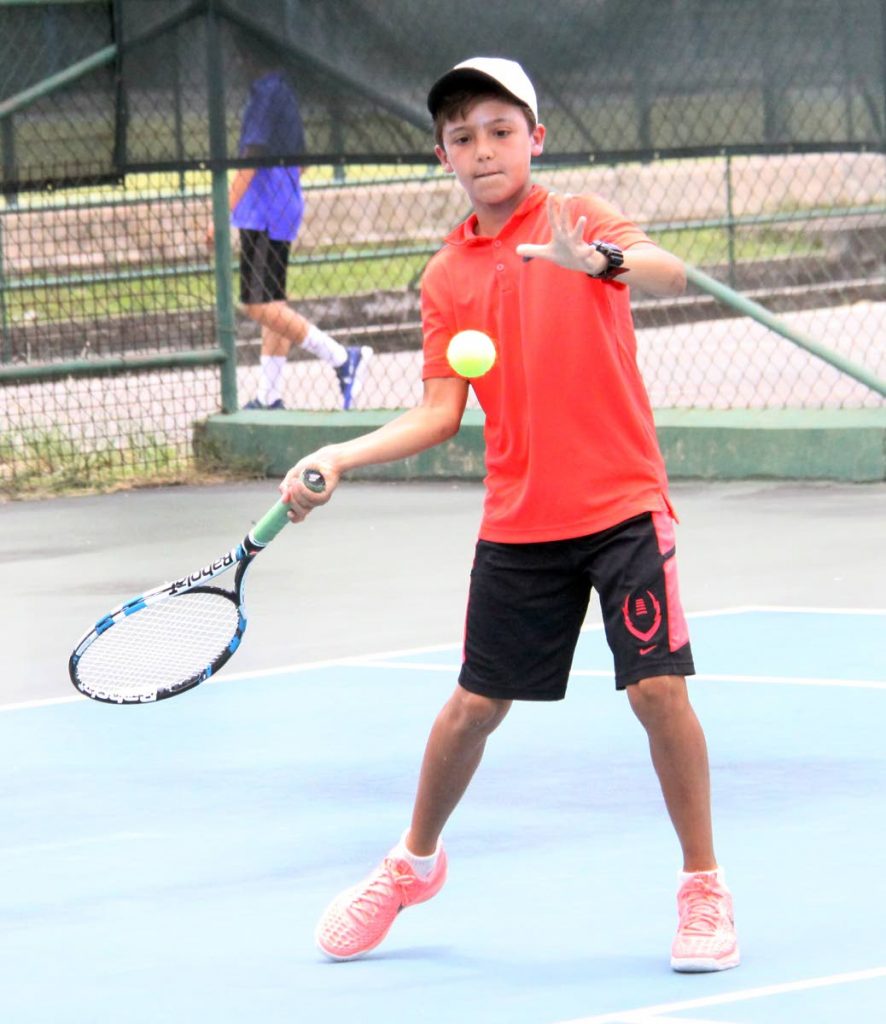 Luca Smasi returns to Tim Pasea, during the Boys Under-14 quater-final match, at the 30th Annual Catch Juniour Tennis Championships held at the National Racquet Centre, Tacarigua. yesterday. Shamsi won 6-0,6-1.