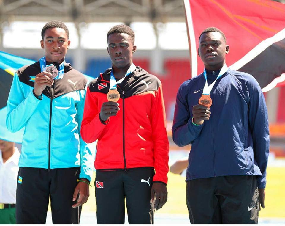 Veayon Joseph of Zenith and TT on the podium after winning gold 
in the boys Under-17 javelin at the 2018 Carifta Games in Bahamas, 
on Saturday.