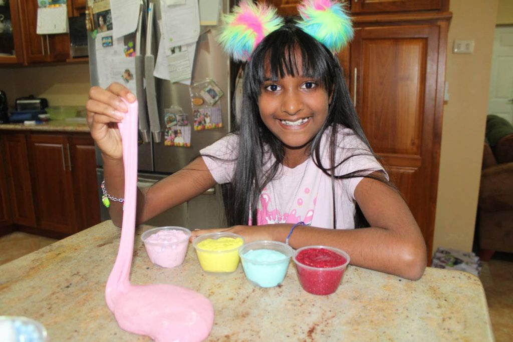 Slime for sale: Anastasia Ramdass poses with some of her finished slime products in her workshop/kitchen at her home in San Fernando.