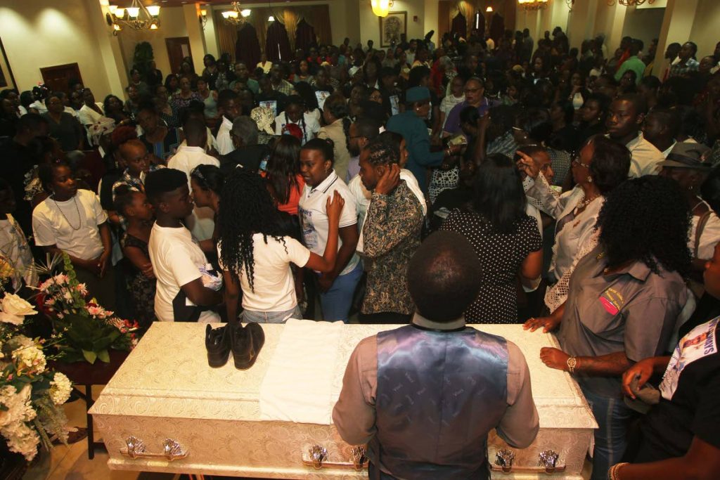 SEND OFF: Mourners packed the chapel of Guides Funeral Home and Crematorium in San Fernando yesterday for the funeral of murdered 19-year-old Rinarco Balgobin.