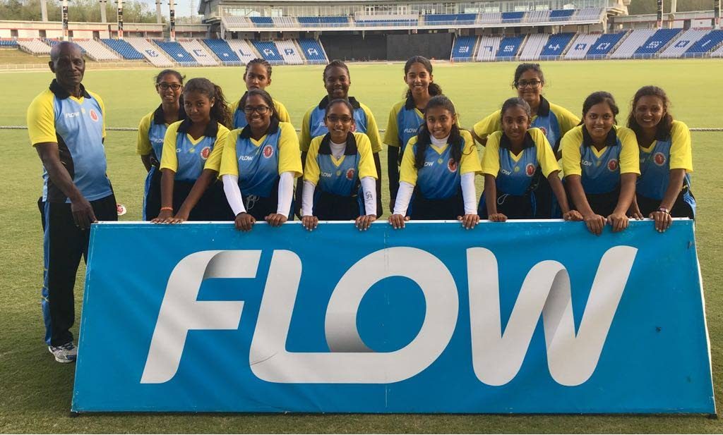 Central Zone cricketers and their coach pose after booking their spot in the final of the Flow Secondary Schools Cricket League final on Friday night at the Brian Lara Academy, Tarouba.