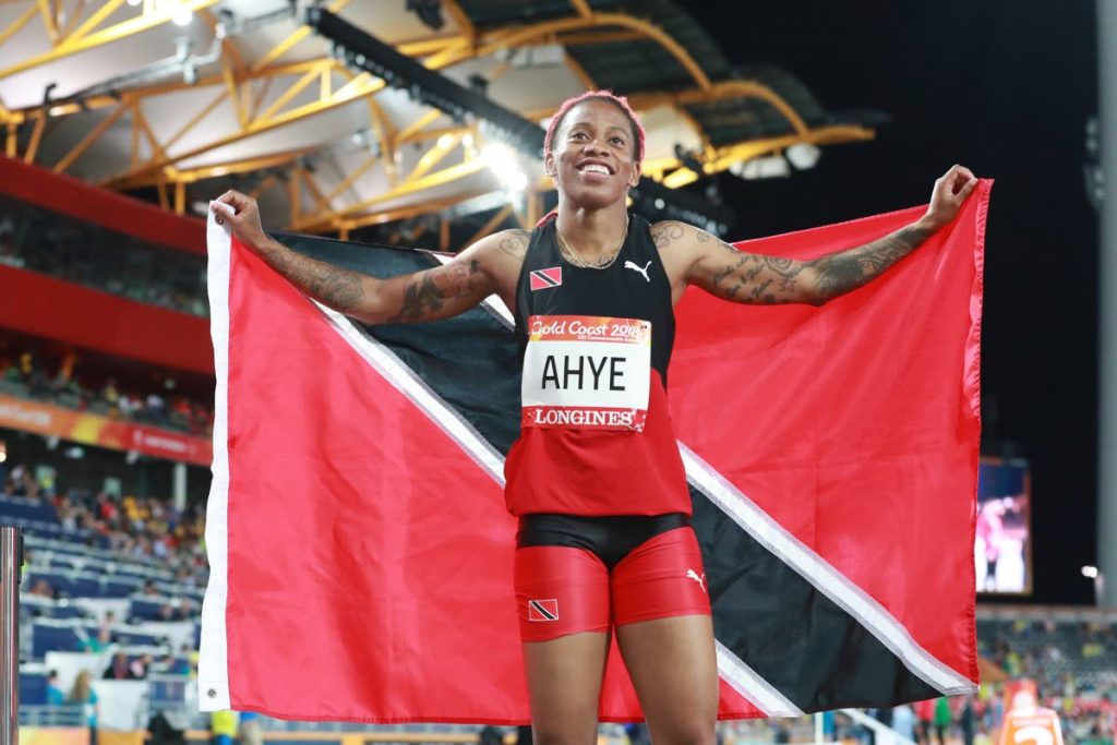 National sprinter Michelle-Lee Ahye displays the national flag after winning the Commonwealth Games 100m final on Monday in the Gold Coast, Australia.