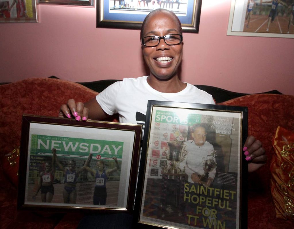 Raquel Ahye, mother of Commonwealth 100m champ Michelle-Lee Ahye, shows framed Newsday clippings of her daughter at her home in Carenage yesterday.