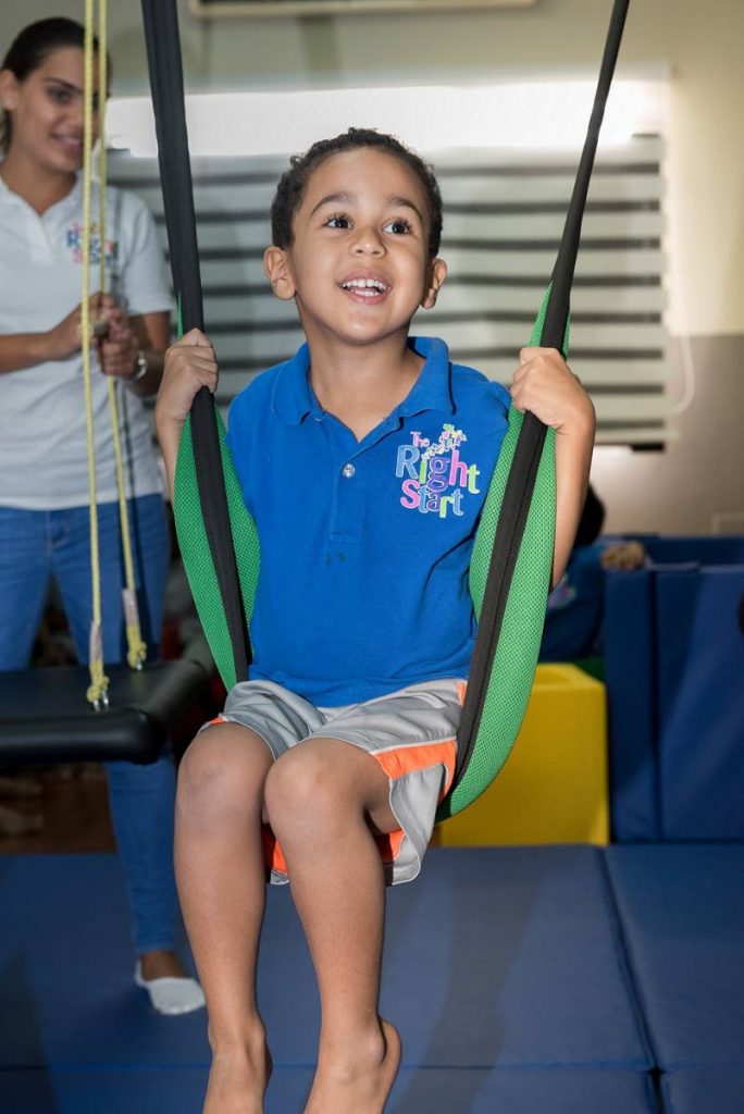 A boy enjoys one of the swings in the Prestige Holdings Sensory Gym at the Right Start Early Intervention Programme for Children with Autism, Carlos Street, Woodbrook. PHOTO COURTESY PRESTIGE HOLDINGS.