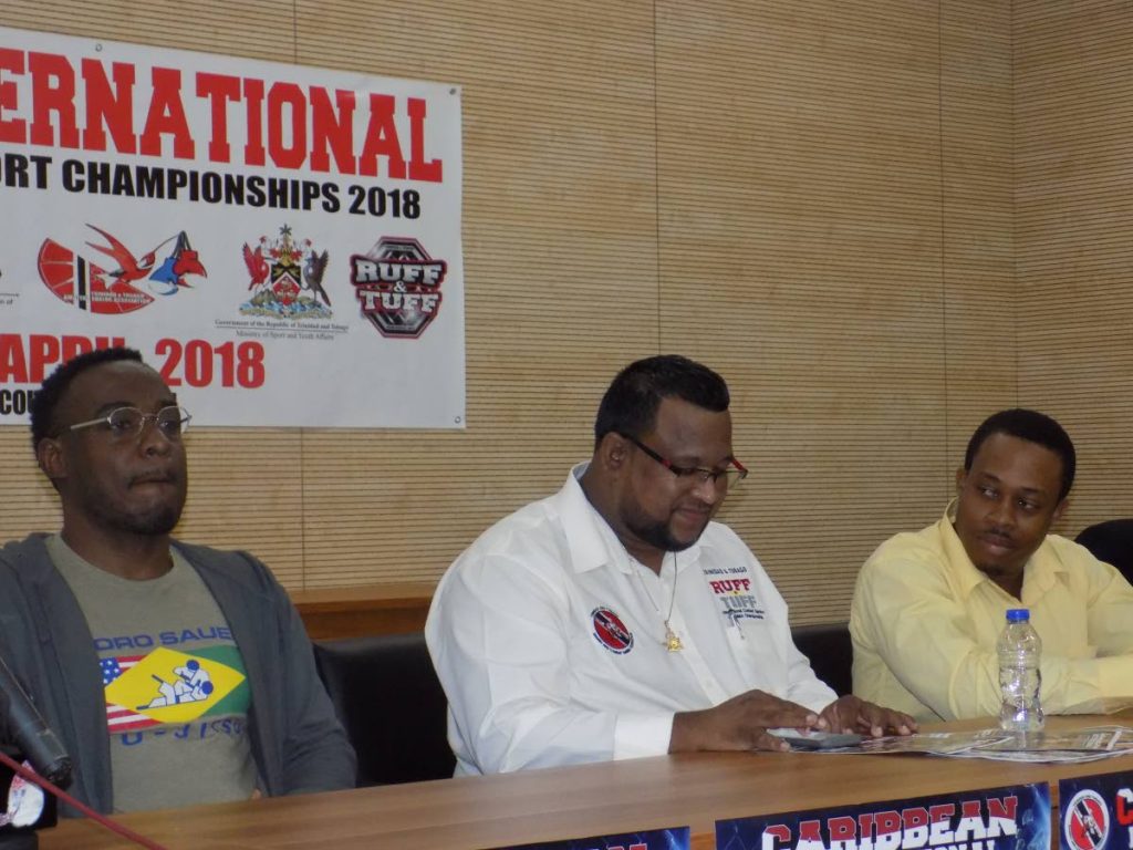 Local representative of Gracie Jiu Jitsu Warren Gill, left, manager of the Ruff and Tuff MMA tournament Jason Fraser and Secretary General of the National Olympic Wrestling Federation Roger Evelyn answer questions from media at a press conference for the tournament at the National Cycling Centre in Couva yesterday.