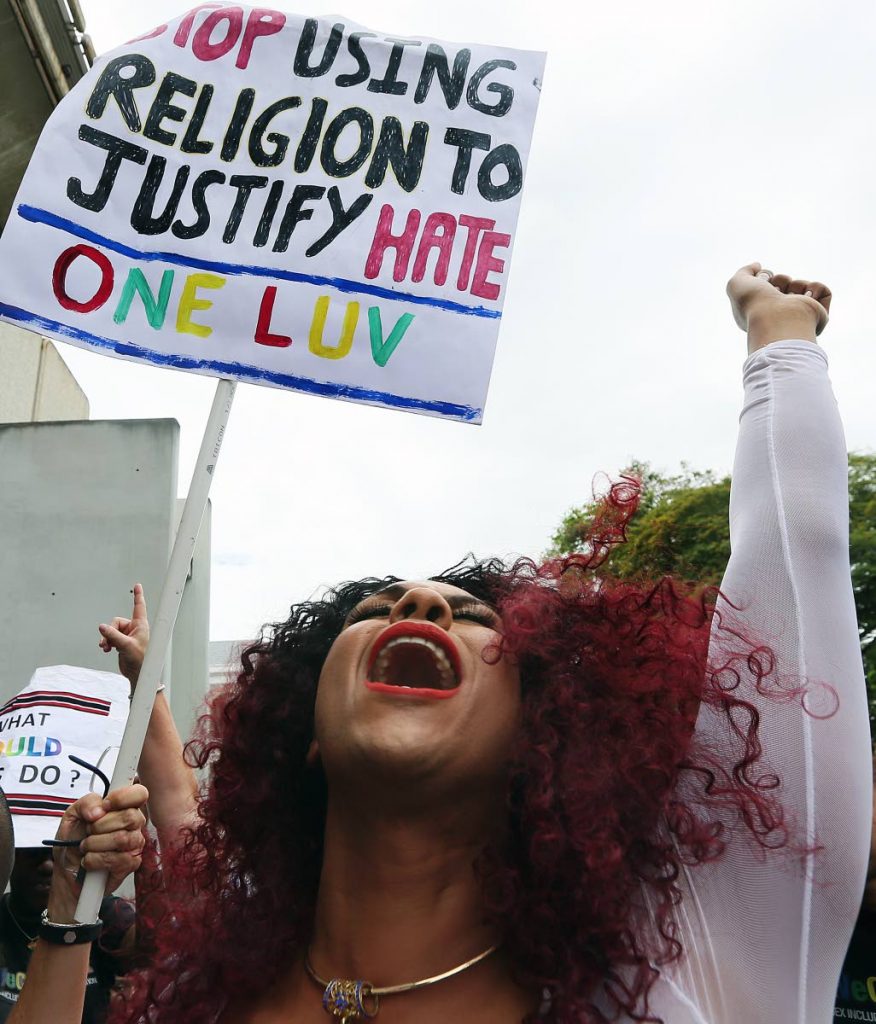 A member of the LGBTQIA community celebrates Justice Devindra Rampersad's ruling that the buggery law is unconstitutional outside the Hall of Justice, Port of Spain last Thursday.
PHOTO BY AZLAN MOHAMMED