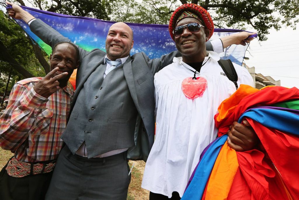 File photo: Gay rights activist Jason Jones celebrates at Woodford Square, Port of Spain with Kelvin Darlington (Saucy Pow), left, and another member of the LBGTQI community after the high court’s ruling decriminalising gay sex.  PHOTO BY AZLAN MOHAMMED