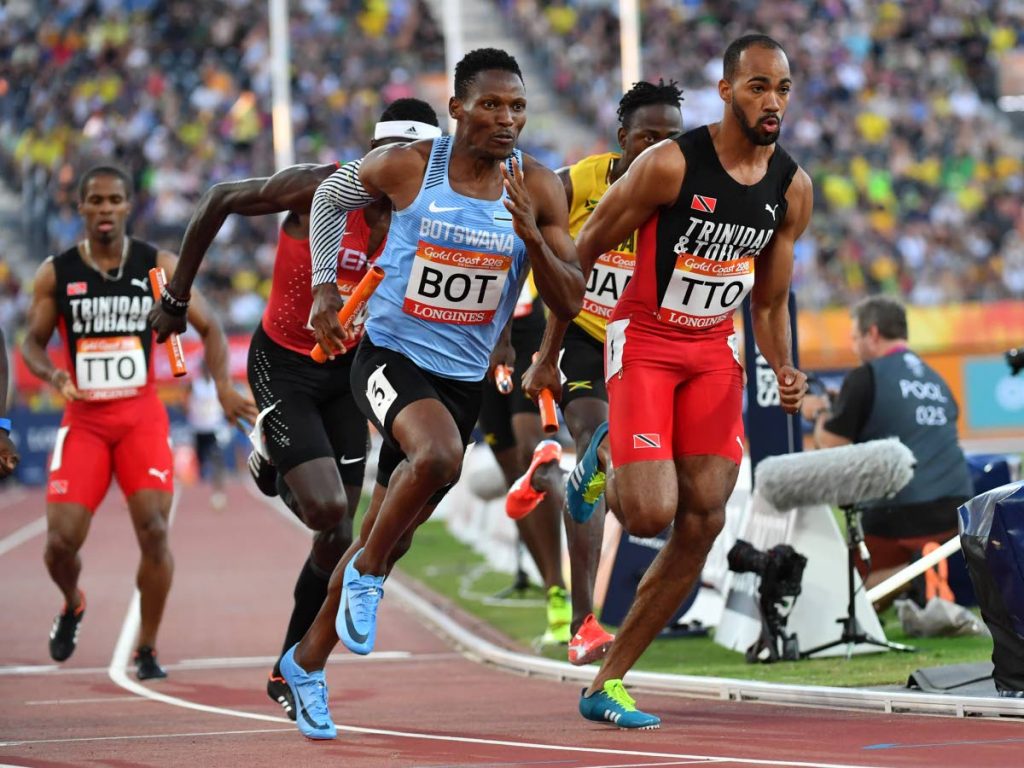 Botswana’s Isaac Makwala (L) and TT’s Machel Cedenio compete in the athletics men’s 
4x400m relay final during the 2018 Gold Coast Commonwealth Games at the Carrara 
Stadium on the Gold Coast yesterday.(AFP PHOTO)