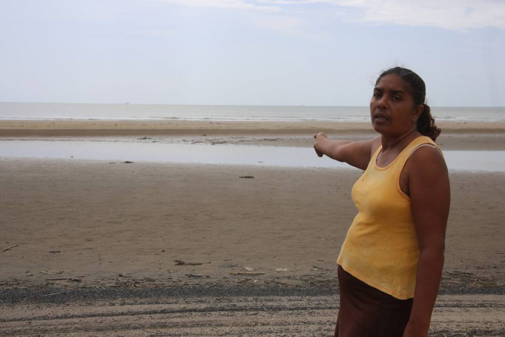 Hematie Sankar points to the Icacos beach where her intended husband, Awardnath Hijarie, and son Nicholas,  were captured last Thursday.