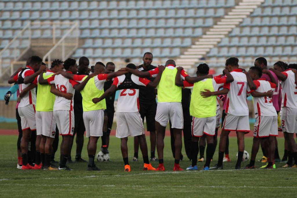 Coach Dennis Lawrence leads the TT team in prayer yesterday during a training session, at the Ato Boldon Stadium, Couva before today’s friendly against World Cup-bound Panama.