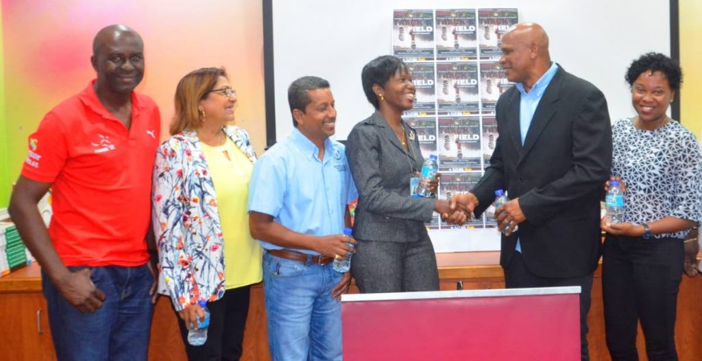 President of the Secondary Schools Track and Field Association (TTSSTFA), Dr Philip Allard (second from right) shakes hands with Shelly Slater, Education Ministry Curriculum Officer, Physical Education and Sport, at the launch of the 2018 Secondary Schools Championships. Present from left: Durly Lucas (NAAA representative), Indra Ramsingh-Geoffrey (TTSSFA PRO), Arnold Rampersad (TTSSTFA Committee member) and Janelle Edwards (TTSSTFA Vice President/IAAF Technical Official).