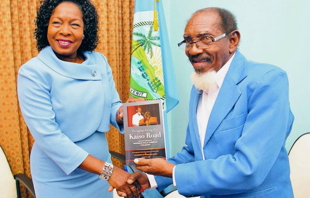 Professor Hollis Liverpool, The Mighty Chalkdust, right, presents THA Secretary of Community Development, Enterprise Development and Labour, Marslyn Melville-Jack, left, with a copy of his book Thoughts Along the Kaiso Road, during the UTT Board of Governors visit to Tobago on Monday.