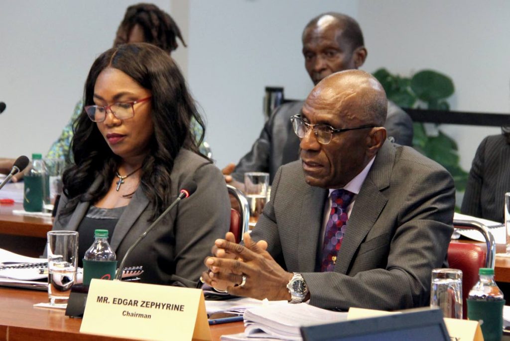 National Commission for Self-Help chairman Edgar Zephyrine responds to questions from the Public Accounts (Enterprises) Committee at the Parliament building yesterday.  With him is administrative head Janice Phillips.