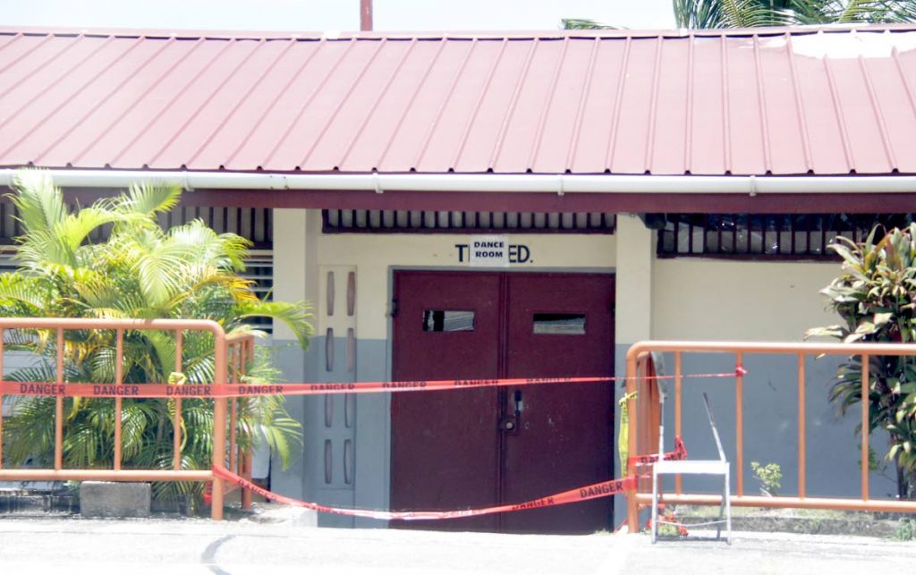 Caution tape is used to cordon off part a block of the San Juan South Secondary School after it was damaged by an electrical fire last Saturday. PHOTO BY ROGER JACOB