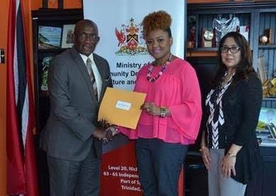 Minister of Community Development Dr. Nyan Gadsby Dolly presents Winston Gypsy Peters with his letter of appointment as Chairman of the National Carnival Commission. Also present was Ms. Angela Edwards, Permanent Secretary of the MCDCA. Photo courtesy Ministry of Community Development.

