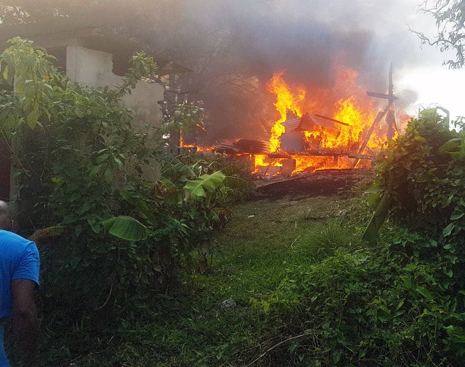 UP IN FLAMES: This house in Cedros burns yesterday afternoon, 
leaving a family of five homeless.