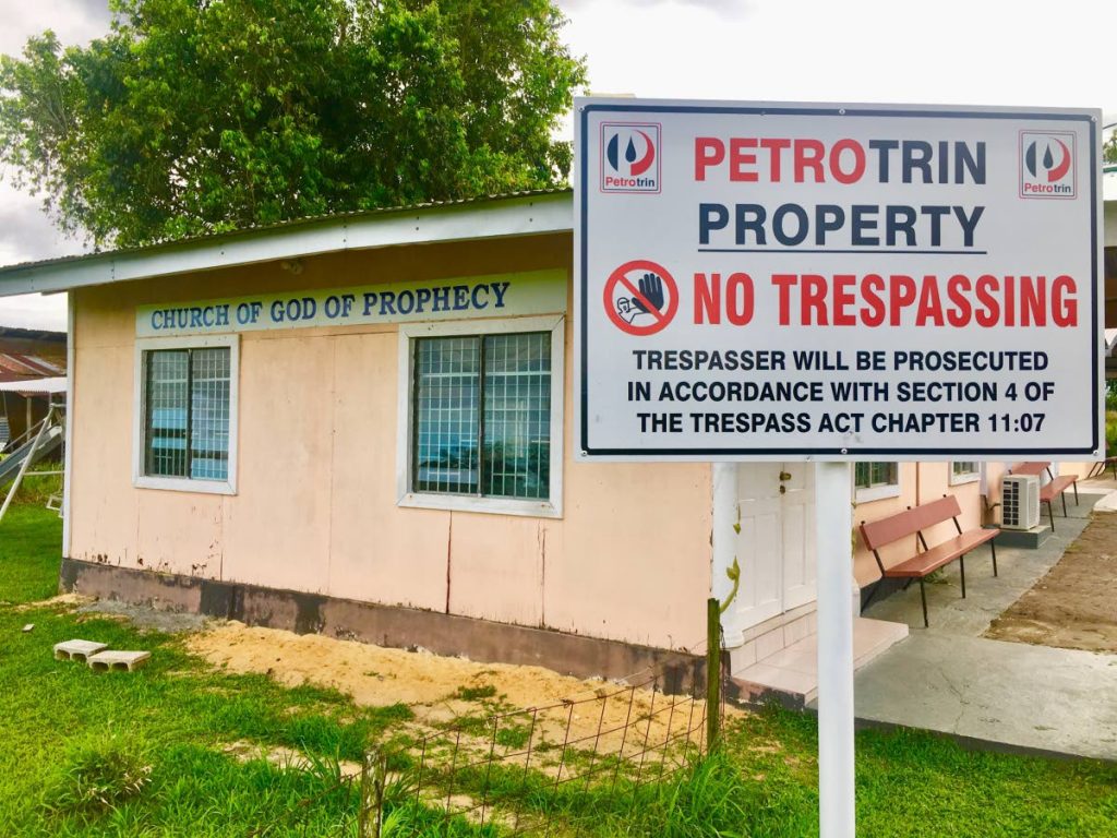 DANGER: A Petrotrin ‘no trespassing’ sign at the front of the Church of God Prophecy in Barrackpore. The oil company wants the building knocked down and members to go elsewhere and pray. PHOTO BY ANSEL JEBODH