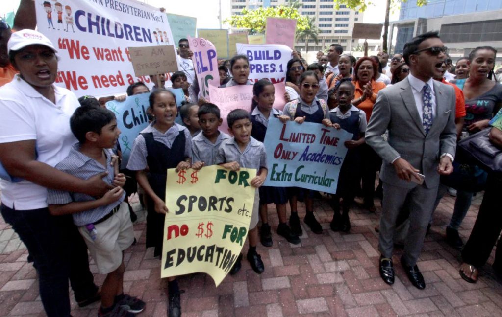 Princes Town MP Barry Padarath rallies parents and students of Princes Town Presbyterian Primary School No 1 in a protest about the conditions of the school and a shift system for classes, outside Parliament on Friday. PHOTO BY ROGER JACOB