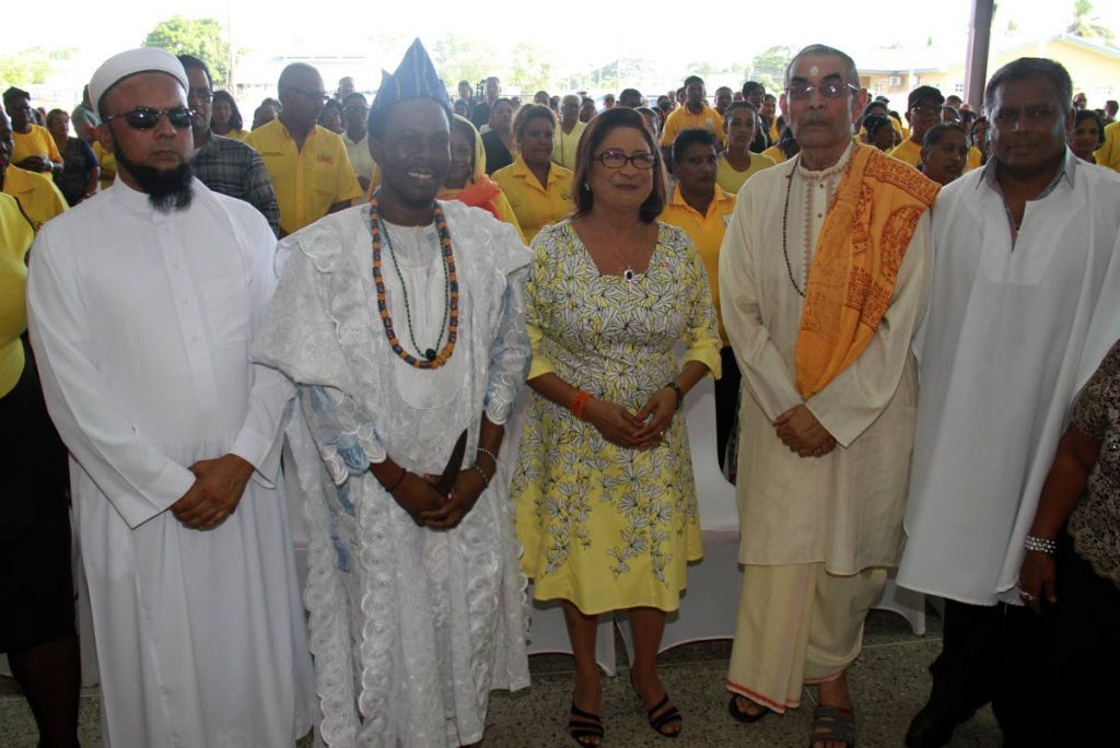 Religious support: UNC political leader Kamla Persad-Bissessar stands with religious leaders during the party's 29th anniversary interfaith service at Couva South Multi-purpose Hall. PHOTO BY ANIL RAMPERSAD.