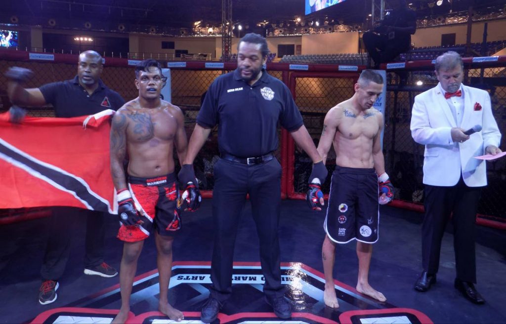 Internationally renowned MMA referee Herb Dean stands with Seon Adhar,left, and Jefferson Espinoza of Colombia. Espinoza was defeated by a rear naked choke from Adhar in the first round.