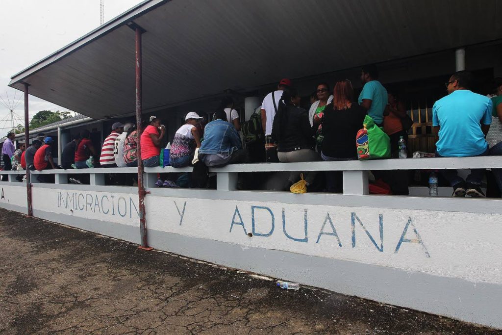 Down in Cedros: Venezuelans wait to be processed by immigration officers at the port in Cedros before returning to the mainland with food supplies on June 1, 2016. Recent reports indicate an estimated 2,000 Venezuelans have sought asylum and activists say the immigrants are exploited for guns, sex and cheap labour. PHOTO BY LINCOLN HOLDER