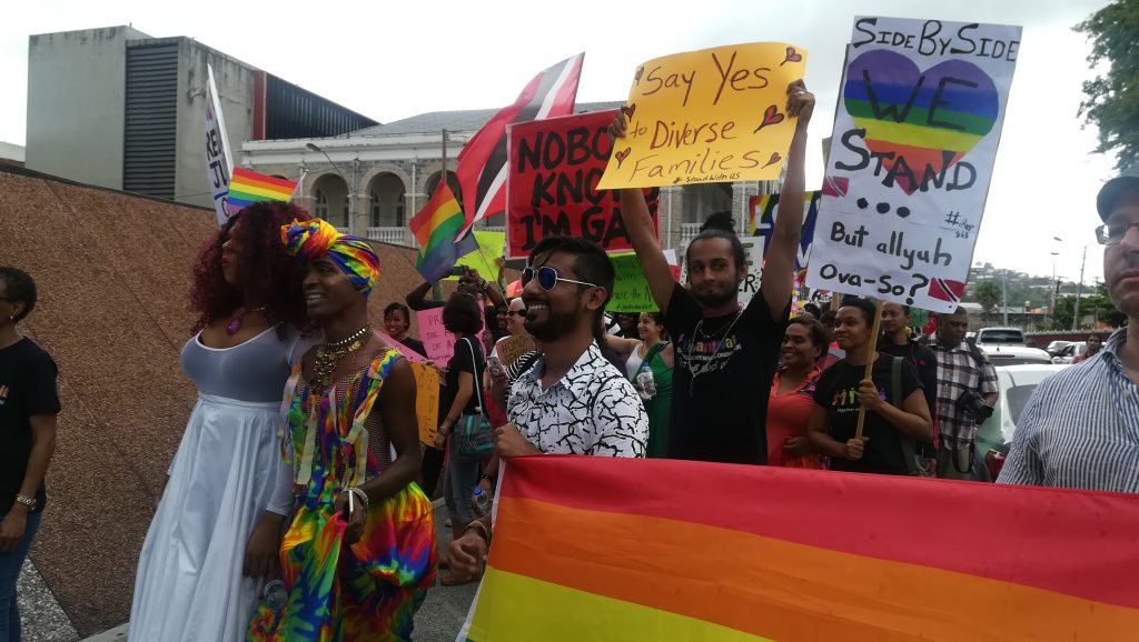 LGBTQI protesters stand near the Hall of Justice waiting for the judgement on the constitutionality of TT's buggery law. Photo: Kalifa Clyne