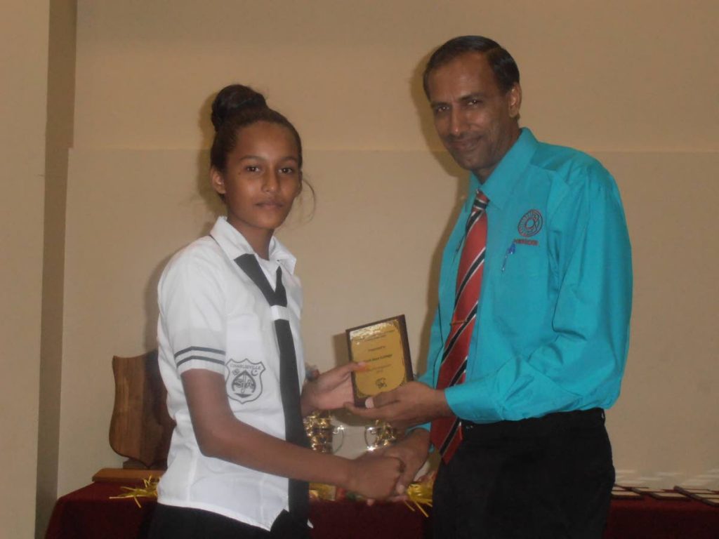 Surujdath Mahabir, right, president of the Secondary Schools Cricket League, presents an award at the 2016 SSCL prize-giving ceremony.