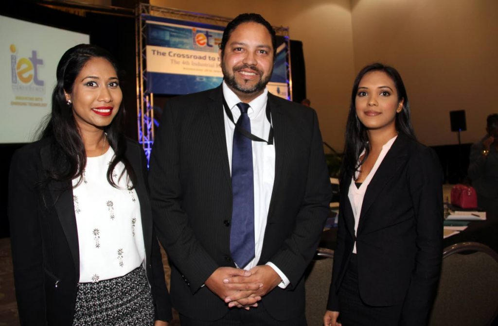 Intellectual Property: (Middle) Regan Asgarali , Controller Intellectual Property Office (TTIPO) with two staff members, (left) Neetu George-Ramsaran and Sharmila Ganpat; both are technical examiners at the TTIPO, at CARIRI's Innovating with Emerging Technolgy Conference at the Hyatt at the Waterfront in Port of Spain. 18-04-18 PHOTO SUREASH CHOLAI