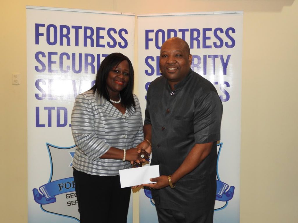 Carlos Neptune CEO of Fortress Security Services Limited right and Paula Kalkman principal of Ascension Anglican Primary School.