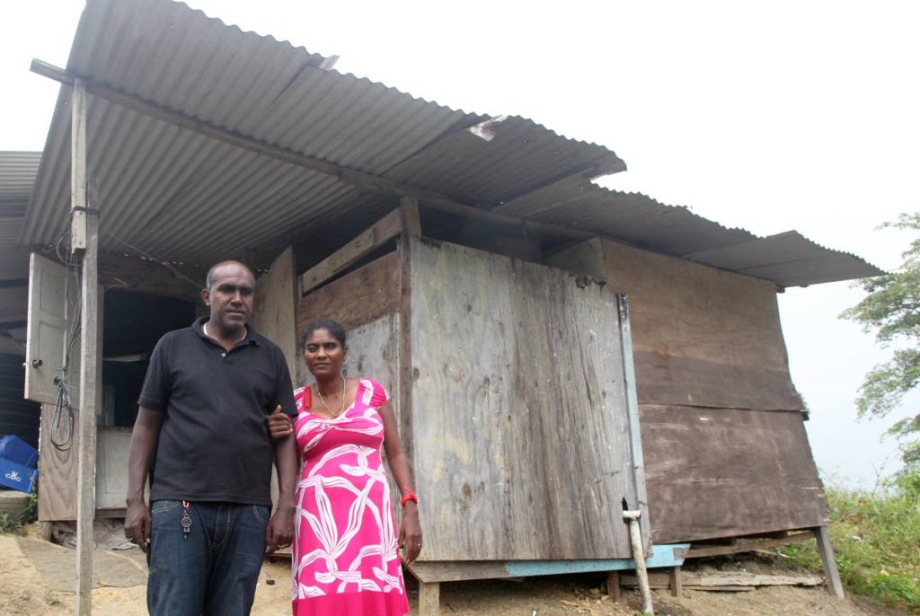Marsha Joseph and her husband Devanand Mohammed in front of their humble home in Tabaquite. 