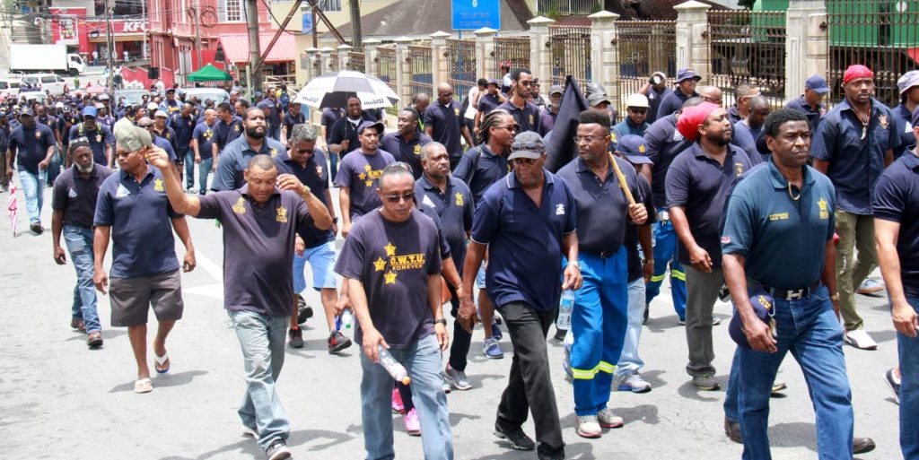 Members of the OWTU trade union take to the streets in San Fernando during May Day obervances yesterday.