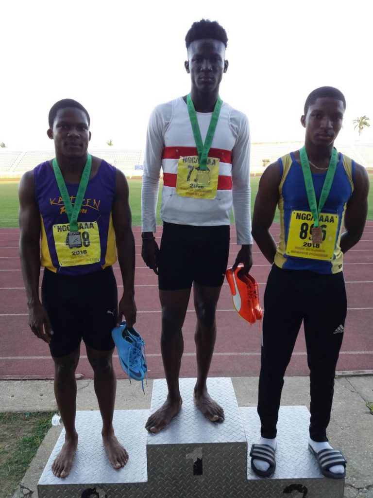 Boys under-17 100m winners, from left to right, Joel Zachary of Pentecostal Light and Life, gold medallist Agard Wilson of Pt Fortin New Jets, and third-place finisher Jaabir Taylor of Kaizen Panthers pose for a podium photo after their race in the Maximising Athletic Invitational, on April 22, at the Manny Ramjohn Stadium, Marabella.