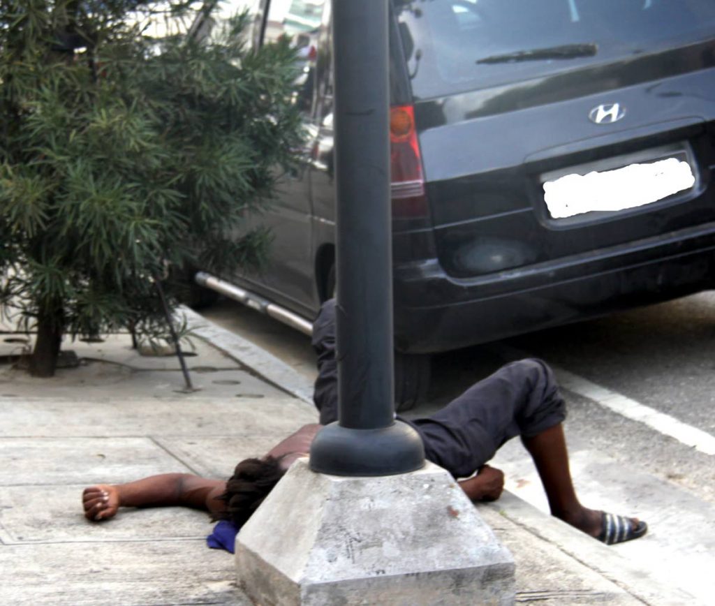 A street dweller sprawls on the pavement on St. Vincent Street Port of Spain.

PHOTO:ANGELO M. MARCELLE