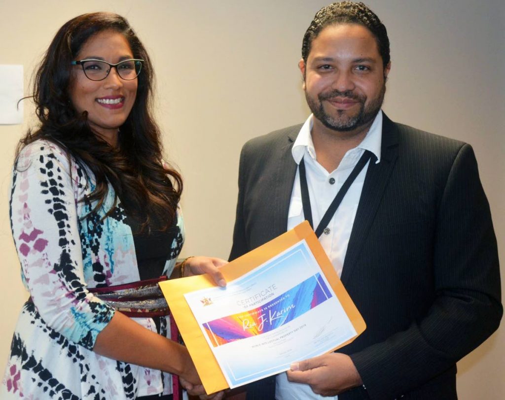 Ria Karim, creator of D’Junction app, receives a certificate from Regan Asgarali, Controller of the Trinidad and Tobago Intellectual Property Office.
