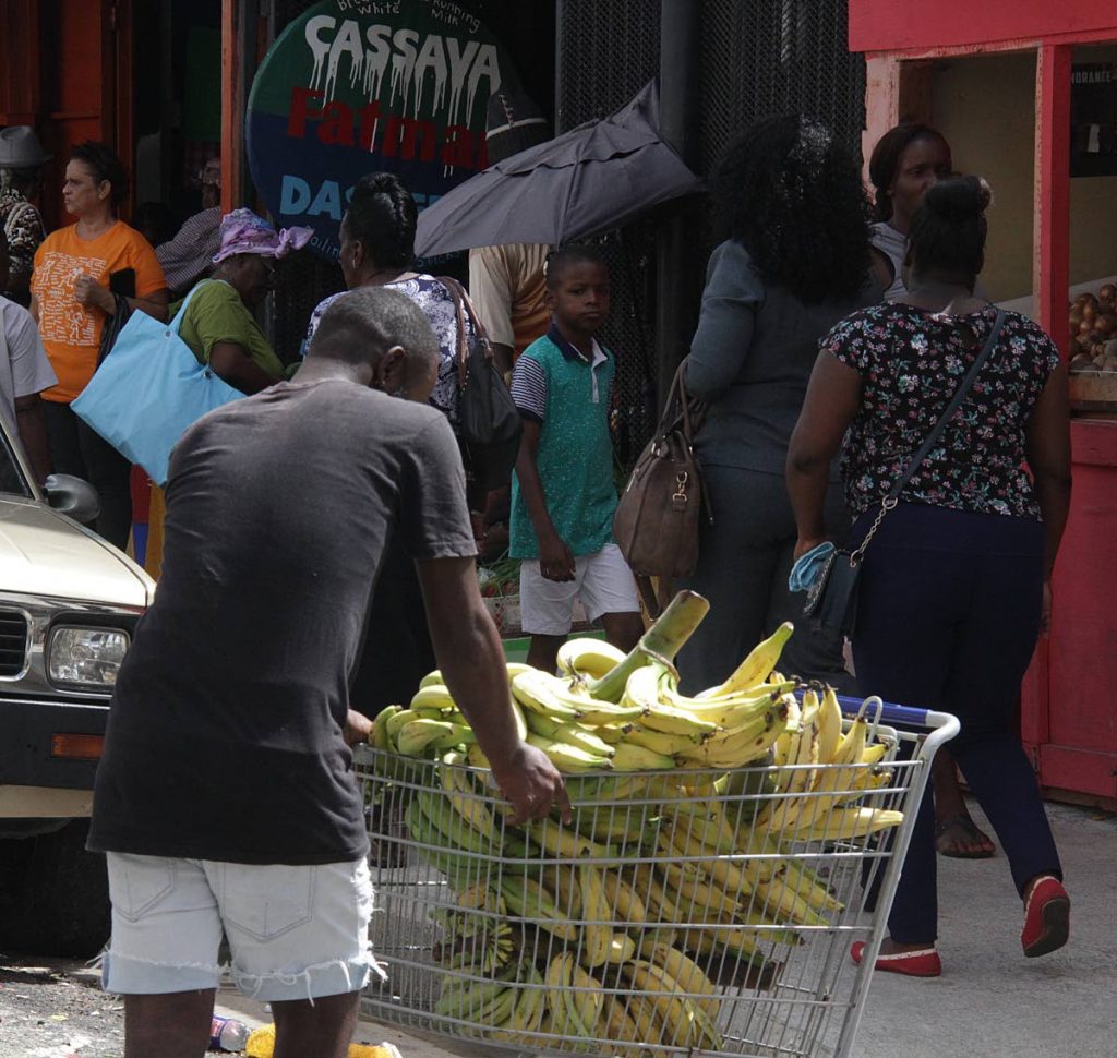 A man pushes a cart filled with plantains, as vendors navigate around the current restrictions by the City council. PHOTO BY ROGER JACOB