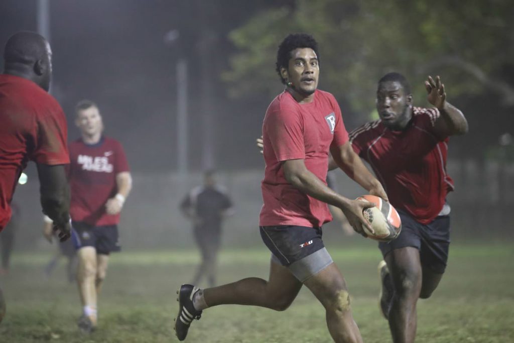 Fiji-born Sefanaia Waqa looks to make a pass during a Trinidad and Tobago rugby training session at President’s Grounds, St Ann’s, recently.