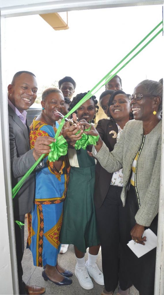 Joel Primus, left, Community Sustainability and Stakeholder Relations Advisor, BPTT helps cut the ribbon to officially open the computer lab at Signall Hill Secondary with, from second left, Allyson Potts, Principal, Form Four student Aaliyah Balgobin, Assistant Secretary in the Office of the Chief Secretary, Marisha Osmond, and Pearl Alman-George, EDPM Coordinator at the school, on April 16.