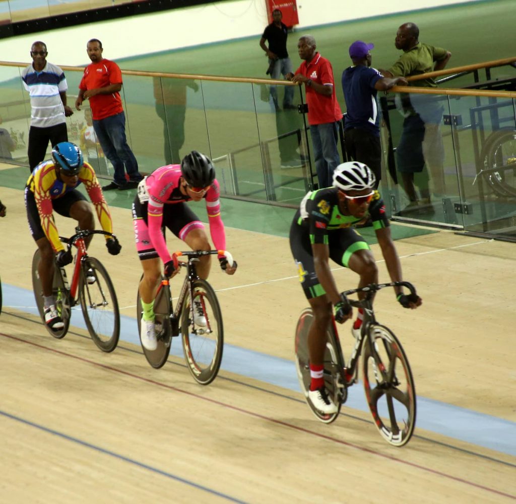 Jabari Whiteman (right) in action during a recent race at the National Cycling Centre, Couva.