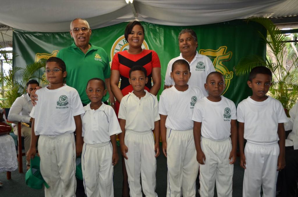 Some of the clinic cricketers pose with Sports Minister Shamfa Cudjoe, club president Andre John, left, and coach Zaffa Khan