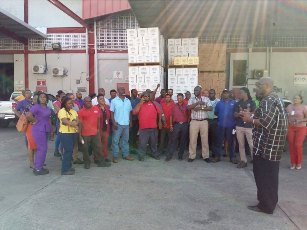 Angostura workers in a May 7, 2018 meeting with Seamen and Waterfront Workers Trade Union (SWWTU) president, Michael Annisette on the Angostura compound, Eastern Main Road, Port of Spain, about the suspension of one of their coworkers. PHOTO COURTESY SWWTU.