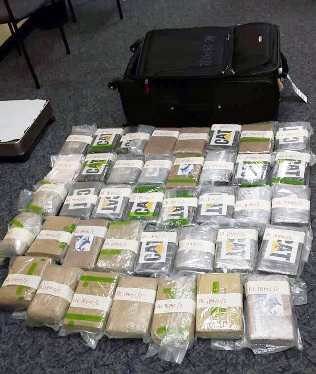 SEIZED: Packets of cocaine, with a combined value of $34.4 million placed on the ground at Piarco Airport on Sunday.
